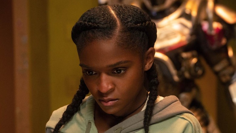 Riri standing in front of her Ironheart suit