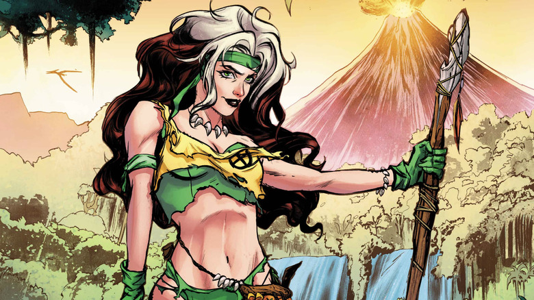 Rogue standing in the Savage Land in torn bikini with wooden spear