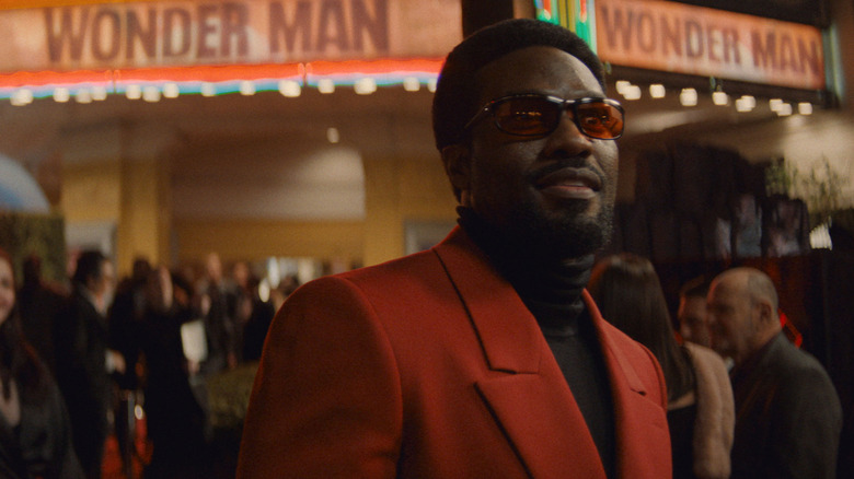 Simon Williams (Yahya Abdul-Mateen II) stands outside the movie premiere of Wonder Man in Wonder Man