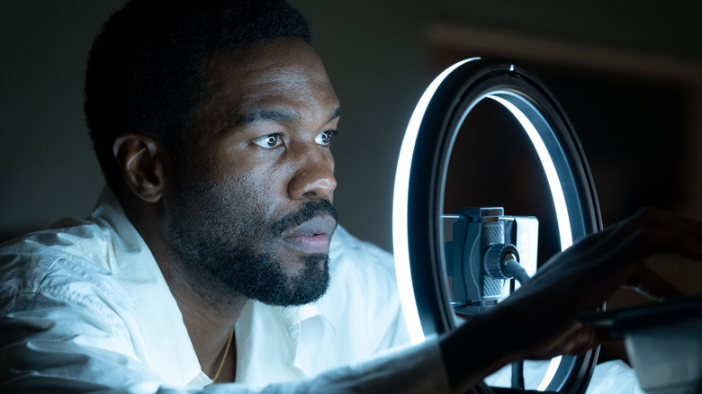 Yahya Abdul-Mateen II's Simon Williams setting up a ring light and a cell phone on Wonder Man
