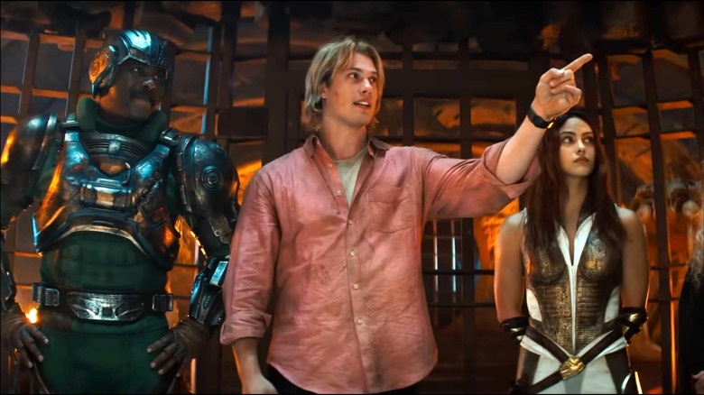 Nicholas Galitzine as Prince Adam, pointing at characters off-screen, next to Duncan (Idris Elba) and Teela (Camila Mendes) in Masters of the Universe (2026)