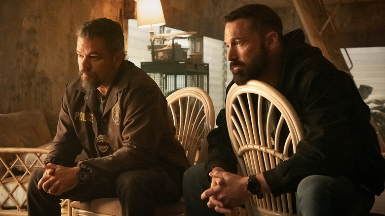 Matt Damon as Lieutenant Dane Dumars and Ben Affleck as Det Sergeant J.D. Byrne sitting with their hands held in front of them in The Rip