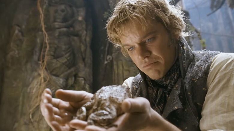 Matt Damon as Will Grimm holding a toad in The Brothers Grimm