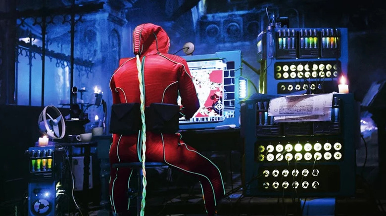 Qohen Leth working on a computer in a V.R. suit in The Zero Theorem
