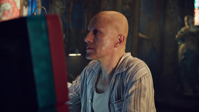 Qohen Leth looking at computers in The Zero Theorem