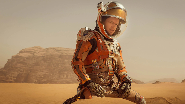 Matt Damon kneeling in sand The Martian
