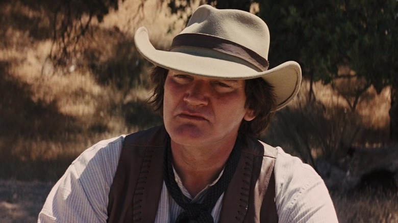 Quentin Tarantino squints under a cowboy hat as Frankie in Django Unchained