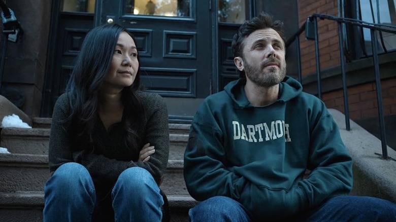 Dr. Rivera and Cobby sitting on a stoop in The Instigators