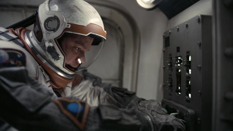 Matt Damon as Dr. Mann stands in a docking station on a spacecraft in Interstellar