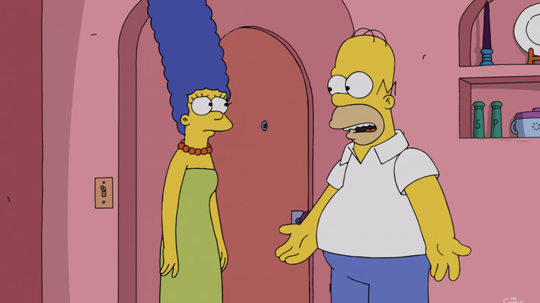 Marge Simpson stands opposite Homer Simpson in their house in The Simpsons