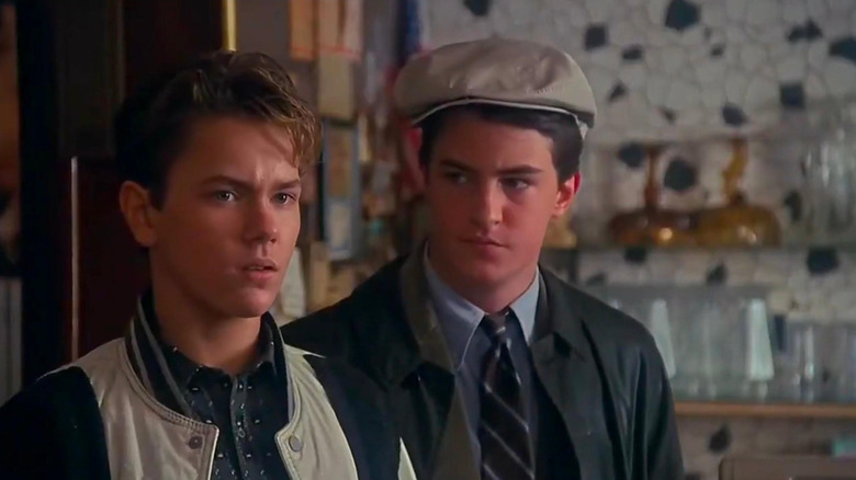 River Phoenix as Jimmy Reardon  shoots a skeptical glance as Matthew Perry's Fred Roberts looks on