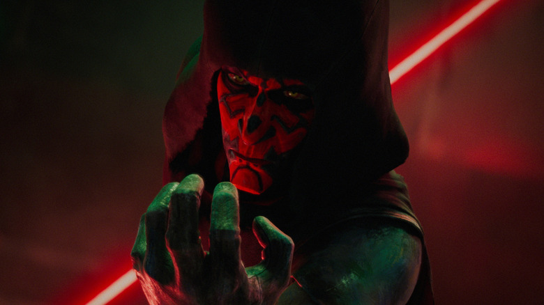 Sam Witwer as the voice of Darth Maul brandishing his lightsaber and using the force in Star Wars: Maul - Shadow Lord