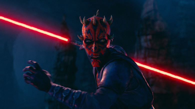 Sam Witwer as the voice of Maul wielding a double-bladed lightsaber and preparing to fight in Star Wars: Maul – Shadow Lord