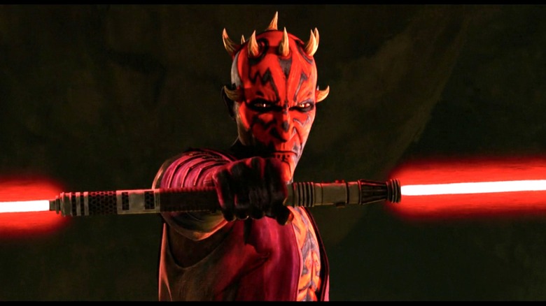 Maul poses with his double-bladed lightsaber