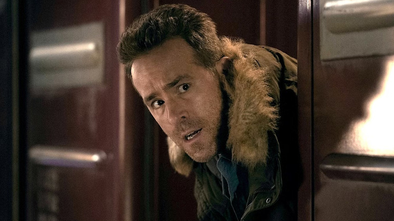 Troy (Ryan Reynolds) looks concerned as he looks out from a train car door in Mayday