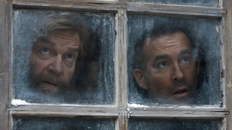 Nilokai (Kenneth Branagh) and Troy (Ryan Reynolds) look out a frosted window in Mayday