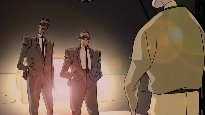 Agent J and Agent K confront an alien disguised as a human in Men in Black: The Series