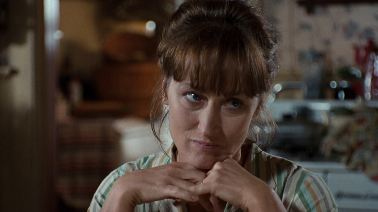 Francesca resting her chin on her hands in The Bridges of Madison County