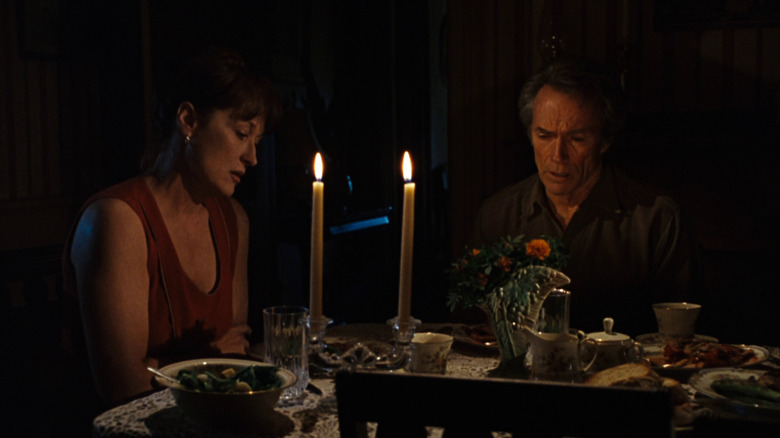 Francesca and Robert Kincaid having dinner together in the dark in The Bridges of Madison County