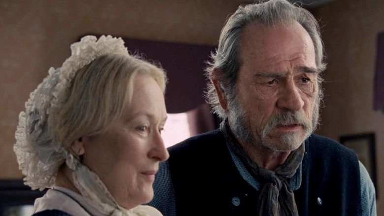 Meryl Streep as Altha Carter stands next to Tommy Lee Jones as George Briggs in The Homesman