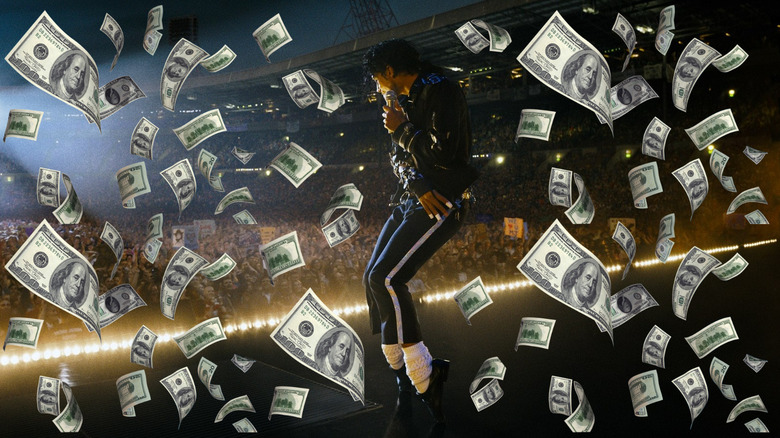 Jaafar Jackson as Michael Jackson dancing on stage in his black outfit surrounded by money in Michael (2026)