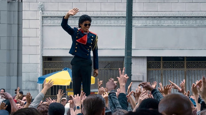 Jaafar Jackson as Michael Jackson standing up and waving to his fans in Michael (2026)