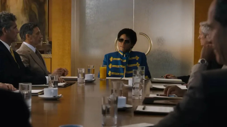 Michael Jackson sitting at the end of a long board room table in Michael