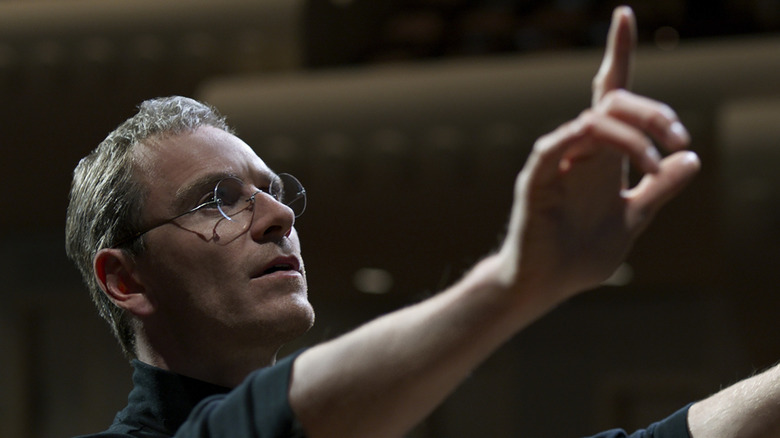 Michael Fassbender as Steve Jobs in Steve Jobs (2015) holding his hands up in the air