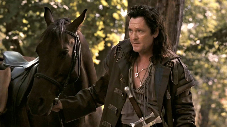 Michael Madsen standing near a horse