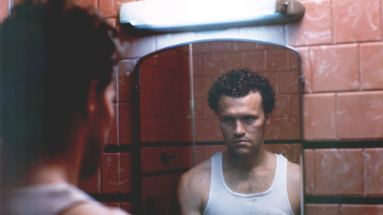 Michael Rooker as Henry staring in the mirror in Henry: Portrait of a Serial Killer