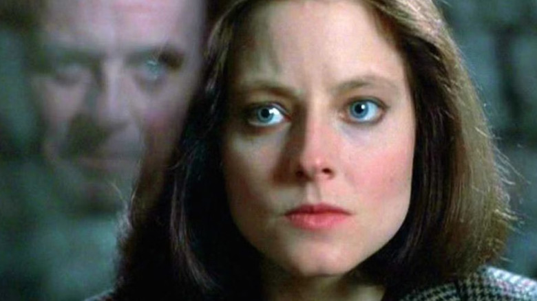 Claris looks intense with Hannibal Lecter's reflection in the glass adjacent to it, a scene of the silence of the lambs