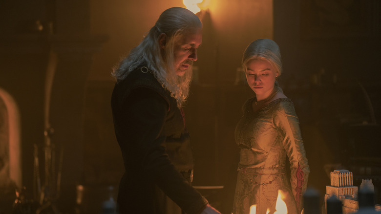 Viserys and young Rhaenyra standing over a fire on House of the Dragon