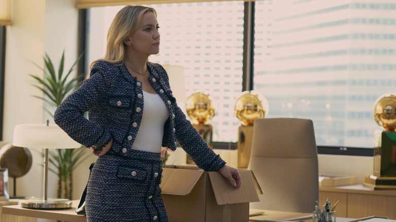 Isla relying on a box on her desk in the race point