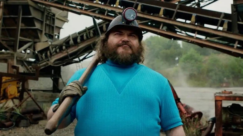 Jack Black brandishes a pickaxe as Steve in A Minecraft Movie