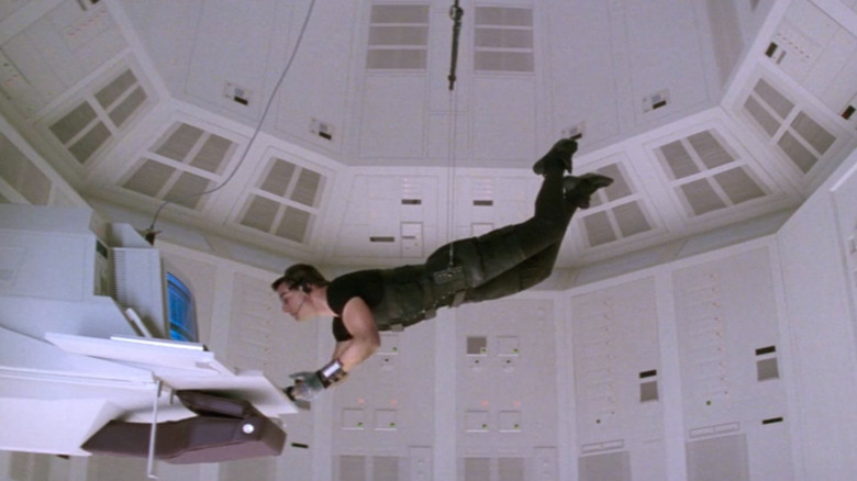 Ethan Hunt (Tom Cruise) dangling in a secured room in Mission: Impossible