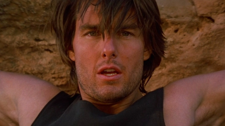 Ethan Hunt (Tom Cruise) hanging from a cliff in Mission: Impossible 2