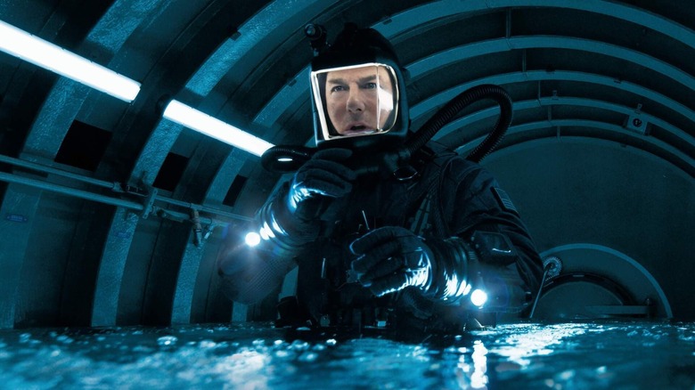 Tom Cruise as Ethan Hunt getting ready to submerge himself under water in Mission: Impossible - The Final Reckoning