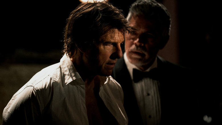 Tom Cruise as Ethan Hunt looking disheveled as Esai Morales as Gabriel watches menacingly in Mission: Impossible - The Final Reckoning