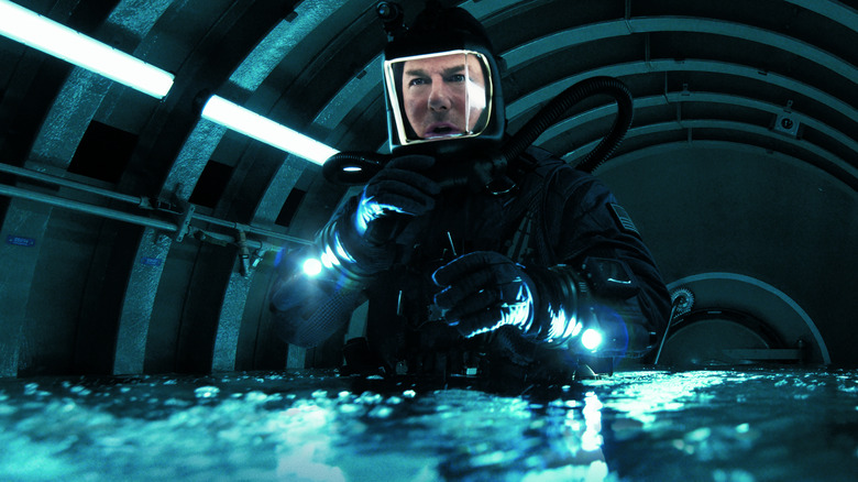 Tom Cruise as Ethan Hunt dressed in a high-tech diving suit in a chamber filling with water in Mission: Impossible - The Final Reckoning