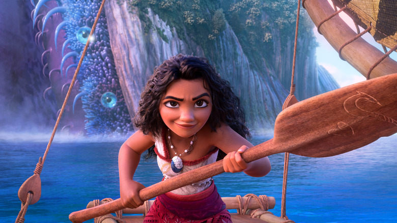 Auli'i Cravalho as Moana, paddling out to sea with a determined look in Moana 2