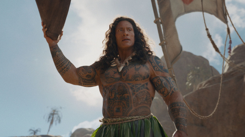 Maui holding the bow of a boat above his head in Moana