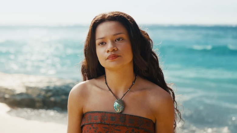 Catherine Laga'aia's Moana looks unimpressed as she stands on a beach in Moana