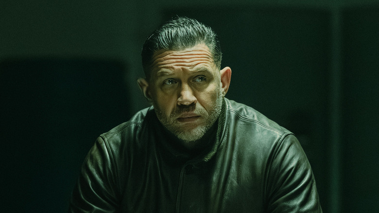 Harry de Souza de Tom Hardy looks right in a dark room in Mobland