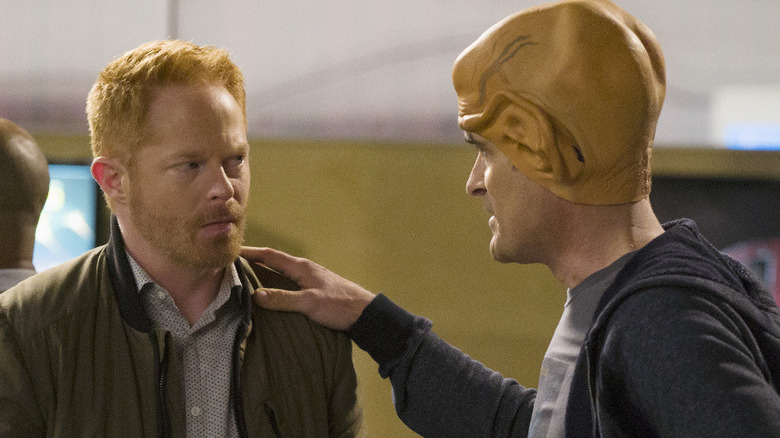 Jesse Tyler Fergusson and Ty Burrell as Mitchell and Phil, talking at a movie theater on Modern Family