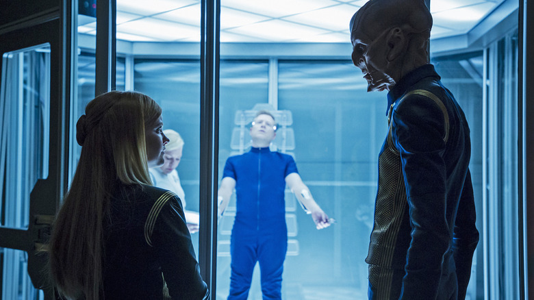 Tilly and Saru looking at each other while Stamets is strapped to a gurney on Star Trek: Discovery