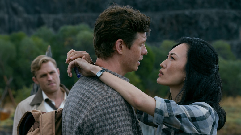 Mari Yamamoto as Keiko hanging onto Anders Holm as Bill with Wyatt Russell as Lee watching in the background in Monarch: Legacy of Monsters season 2