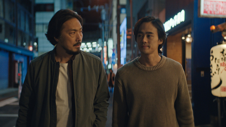 Takehiro Hira as Hiroshi Randa and Ren Watabe as Kentaro Randa walking together in Monarch: Legacy of Monsters