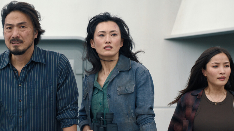 Takehiro Hira as Hiroshi, Mari Yamamoto as Keiko, and Anna Sawai as Cate standing together on a boat in Monarch: Legacy of Monsters