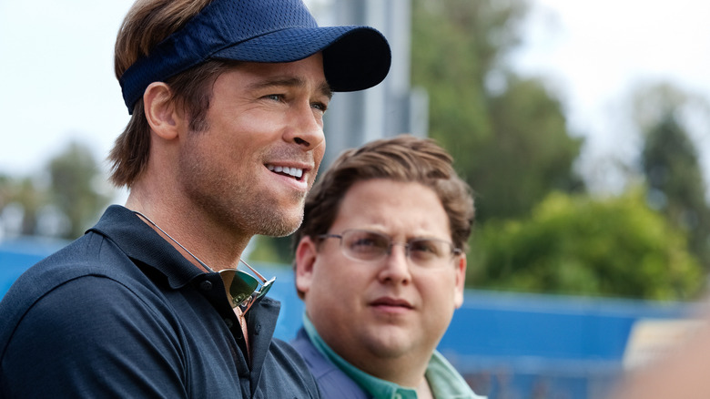 Brad Pitt in the role of Billy Ben and Juna Hill in the role of Peter Brand standing together 