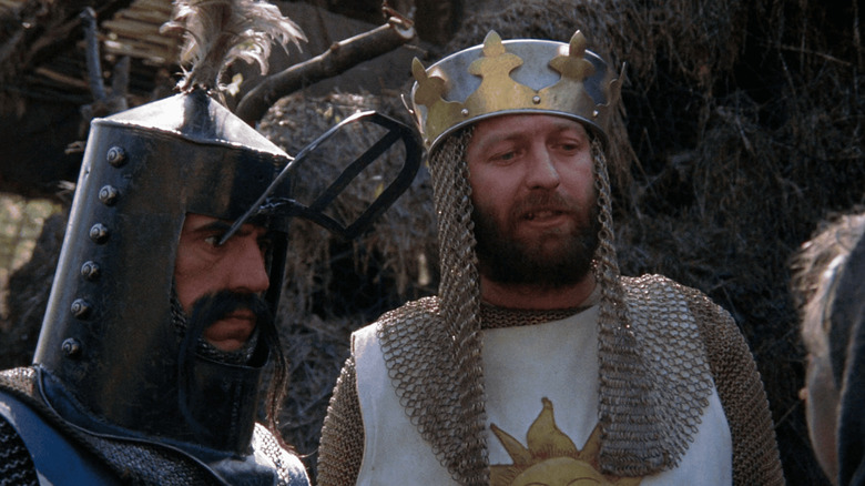 Graham Chapman as King Arthur and Terry Jones as Sir Belvedere chat with a peasant in Monty Python and the Holy Grail